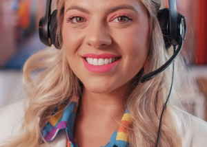 Close-up portrait of a smiling woman wearing a headset